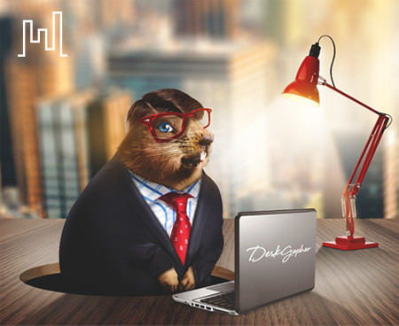 A Desk Gopher in a suit working at a laptop